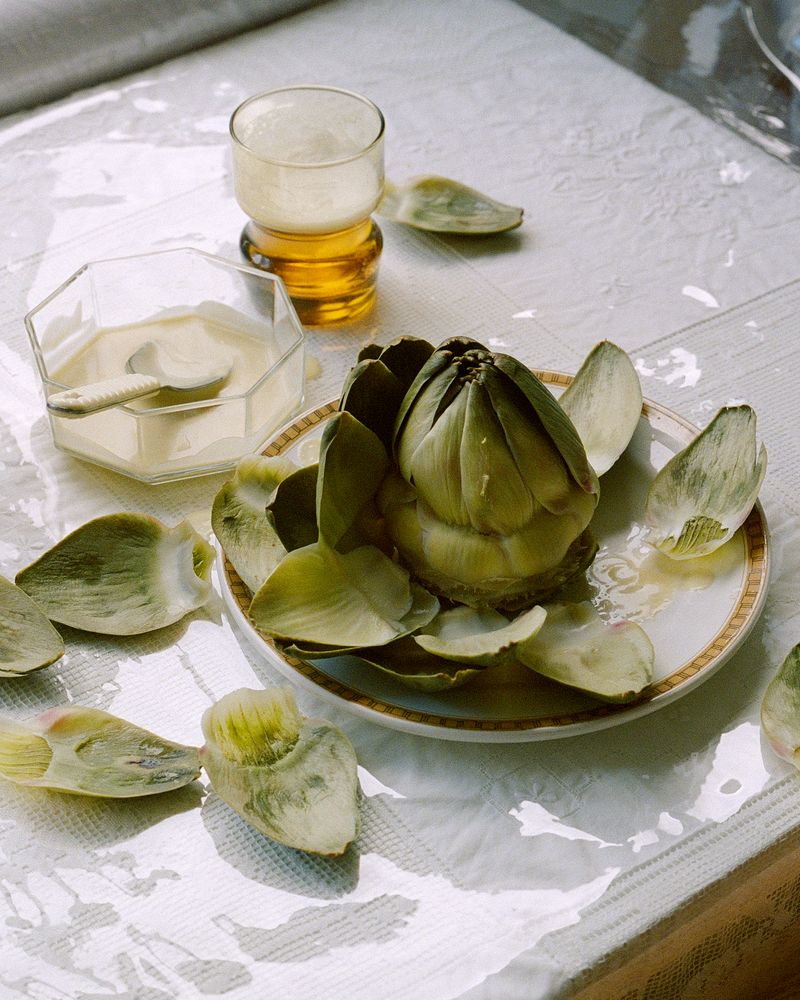 Green artichoke served with glass of beer 